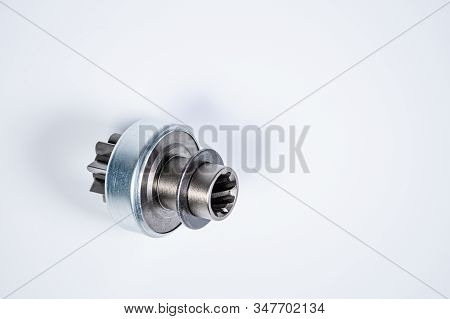 New Spare Parts - Starter Gear Drive For Motor Starter On A Gray Background. Classic Gear Transmissi