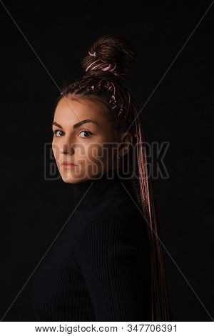 A Beautiful Girl With Pink Afro Or Zizi Pigtails And Brown Eyes Looks Sternly At The Camera On A Bla