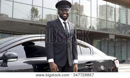 Handsome Cabdriver Sincerely Smiling Near His Luxury Vehicle, Elite Service