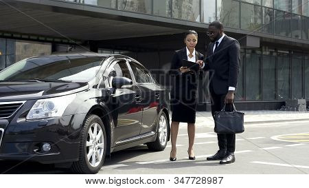 Scrupulous Secretary Clarifying Contract Details With Boss Near Parked Car