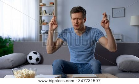 Excited Football Fan Crossing Fingers For Good Luck, Supporting National Team