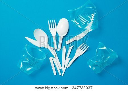 White Single-use Plastic Knives, Spoons, Forks On A Blue Background. Say No To Single Use Plastic. E