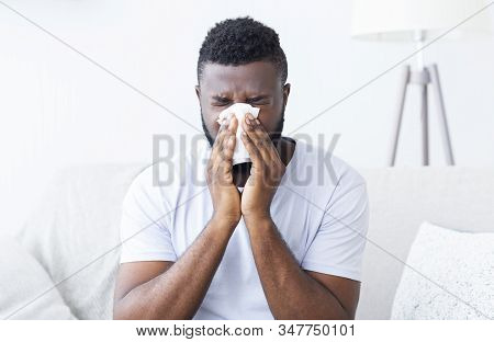 Virus Or Influenza. Sick African Guy Cleaning His Snotty Nose At Home