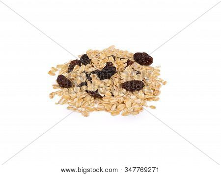 Pile Of Dried Black Raisins And Oatmeal On White Background