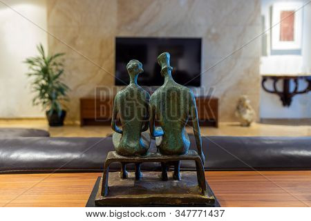 Man And Woman Couple Statuette Watching Tv In Living Room