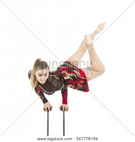 Beautiful Equilibrist In A Red And Black Suit, Performs Exercises On Acrobatic Canes.