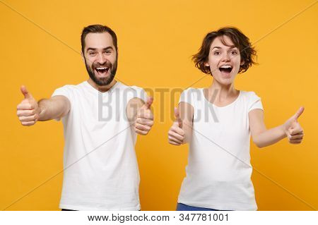 Excited Young Couple Friends Bearded Guy Girl In White Blank Empty T-shirts Posing Isolated On Yello