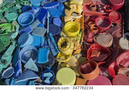 Close-up Of Plastic Trash Spilled On The Beach, Dirty Sea Sandy Shore, Environmental Pollution, Ecol