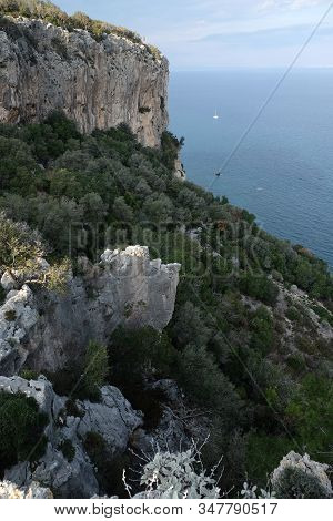 High Impregnable Plateau With Mountain Vegetation On Top And Calm Sea Far And Down On Skyline On Sun