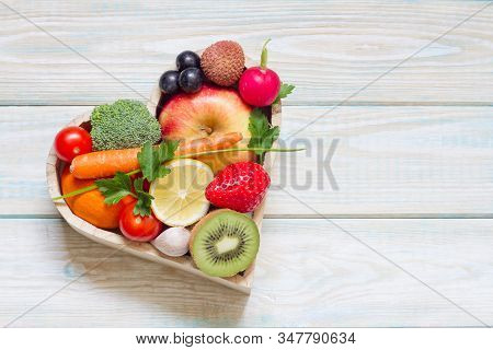 Healthy Food In Heart And Cholesterol Diet Concept On Blue Boards