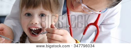 Female Dentist Look At Open Mouth Litle Happy Girl Child Againlt Hospital Office Background Portrait