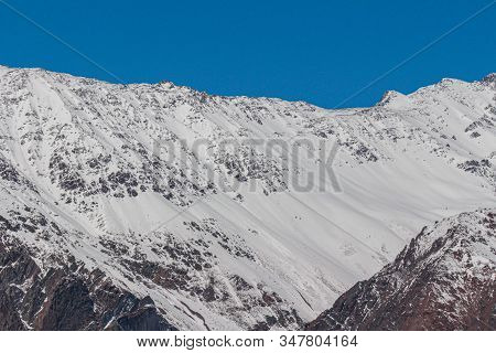 Natural Monument El Morado, Central Andes Of Chile. A Snowy Mountain Slopes