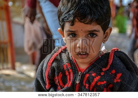 Yadgir,karnataka/india-december 20th 2019:little Indian Girl Setting On The Temple Floor