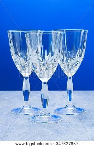 Three Crystal Glass With Close-up On A Blue Background