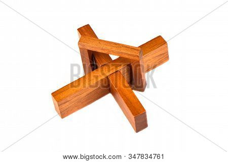 Wooden Cross Puzzle Isolated On A White Background.