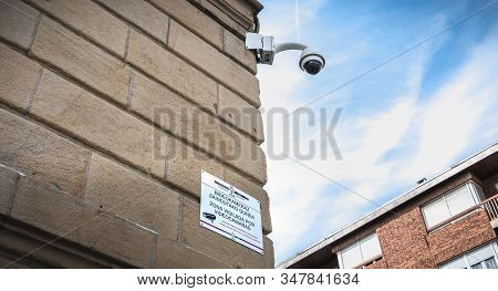 Irun, Spain - April 27, 2018: Surveillance Camera On The Town Hall Wall And A Sign Indicating A Vigi