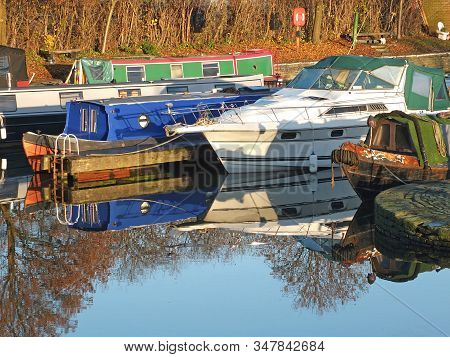 Old Narrow Boats Converted To Houseboats Moored In The Marina At Brighouse Basin In West Yorkshire