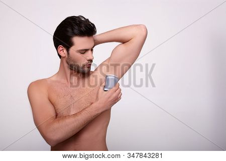 Cute Charming Sexy Muscular White Man With Dark Hair, Raised His Left Hand And Applies Deodorant On 