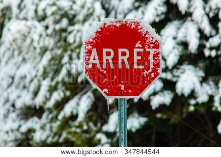 Adverse Weather Conditions On Public Roads And Highways. A French Canadian Traffic Sign Saying Stop 