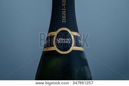Paris, France - Jan 1, 2020: Close-up Detail Of Cremant Dalsace Sparkling Wine Against Blue Backgrou