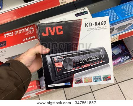 Dortmund, Germany - Mar 25, 2019: Man Customer Hand Holding Package Of New Auto Radio Manufactured B