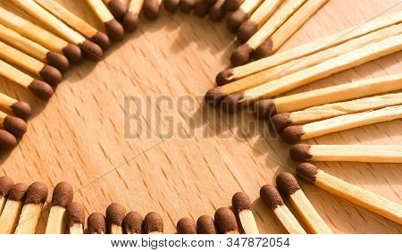 Wooden Safety Matches On A Wooden Background Arranged In The Shape Of A Heart. Matchsticks In The Sh