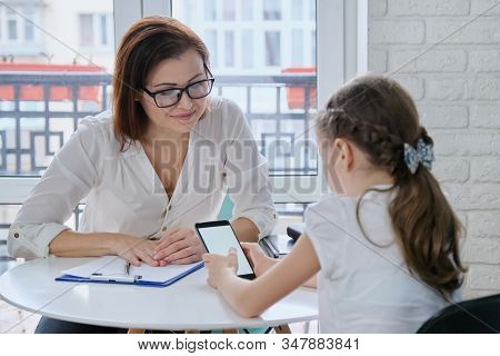 Girl At Meeting With Psychologist Showing His Social Page On Smartphone, Talking Psychiatrist And Ch