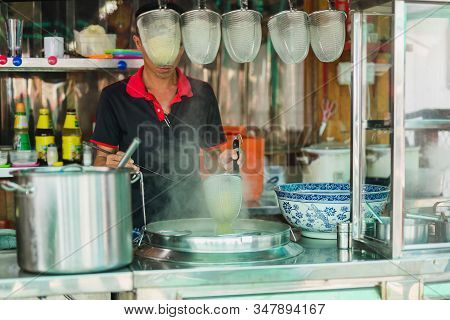 Man Making Noodles Soup At Noodle Stall On Street.