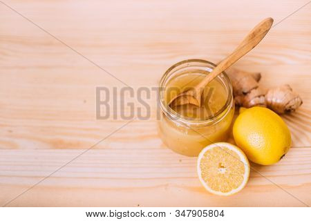 Honey, Lemon And Ginger Root. Ingredients On A Wooden Background. Concept Of Traditional Treatment. 