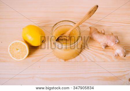 Honey, Lemon And Ginger Root. Ingredients On A Wooden Background. Concept Of Traditional Treatment.