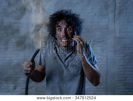 Funny Man Holding Burnt Cable Calling Electrician For Help. Diy Repairs Concept