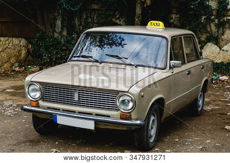 Tibilisi - December 11 2019: Old Retro Classic Lada Taxi Car Parked Outdoor. Vintage Cab Service Bac