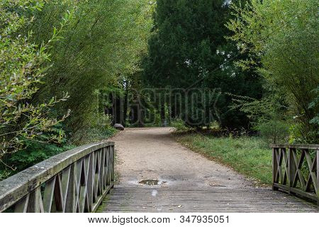 Walking In The Palace Garden Of Charlottenburg On An Autumn Day, Small Bridges Over The River , A Di