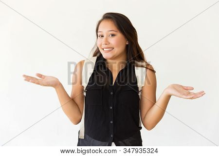 Uncertain Young Woman Gesturing With Hands. Doubtful Young Asian Woman Gesturing With Hands And Look
