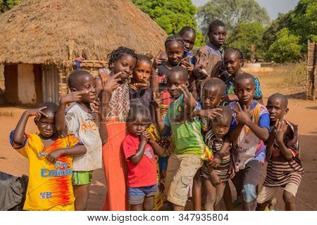 Bissau, Guinea-Bissau - January 5, 2020: group of African Kids looking at the camera in rural Guinea-Bissau