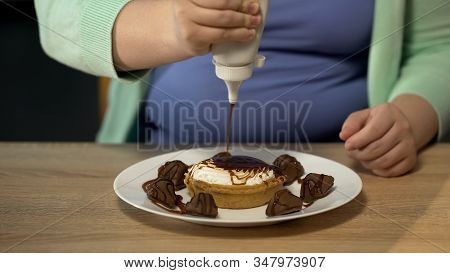 Obese Female Adding Too Much Chocolate To Pastry, Overeating Sugar And Sweets
