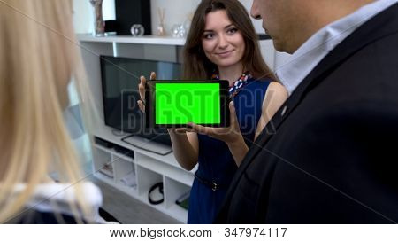 Female Broker Showing Green Screen Tablet With App For Smart House Management