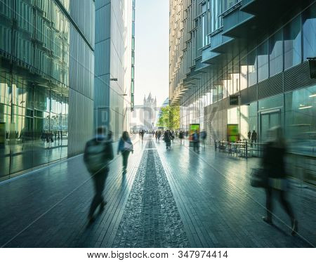 business people, modern buildings and Tower Bridge, London, UK