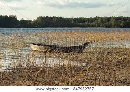 Boat Moored On The Mudy Shore Lake