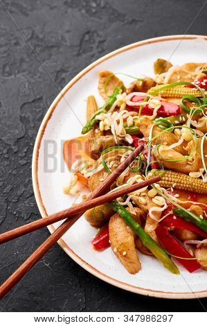 Chicken Chop Suey In White Plate At Black Slate Background. Chop Suey Is American Chinese Cuisine Di