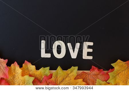 Love Day Concept. The Wooden Text Remain To Valentine's Day With Maple Leaf And Black Background.val