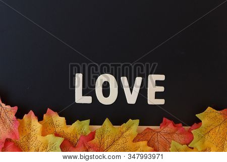 Love Day Concept. The Wooden Text Remain To Valentine's Day With Maple Leaf And Black Background.val