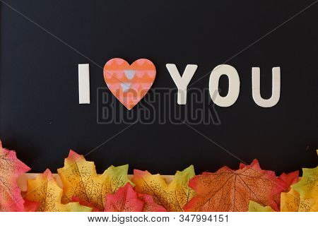 Love Day Concept. The Wooden Text Remain To Valentine's Day With Maple Leaf And Black Background.val