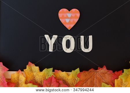 Love Day Concept. The Wooden Text Remain To Valentine's Day With Maple Leaf And Black Background.val