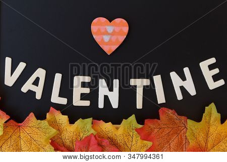 Love Day Concept. The Wooden Text Remain To Valentine's Day With Maple Leaf And Black Background.val