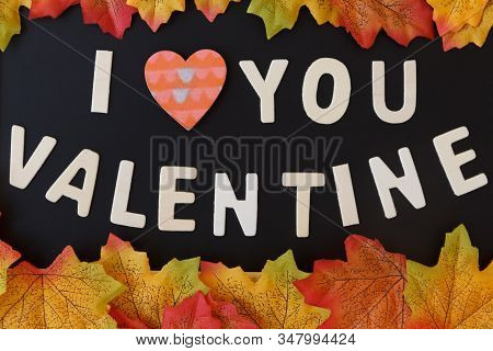 Love Day Concept. The Wooden Text Remain To Valentine's Day With Maple Leaf And Black Background.val