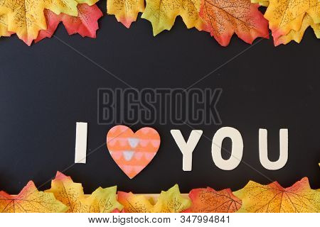 Love Day Concept. The Wooden Text Remain To Valentine's Day With Maple Leaf And Black Background.val
