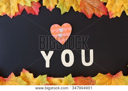 Love Day Concept. The Wooden Text Remain To Valentine's Day With Maple Leaf And Black Background.val