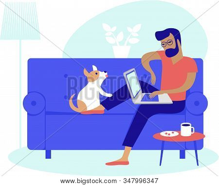 Young Man Using Laptop At Home Working As Freelancer 