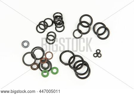 Hydraulic And Pneumatic O-rings In Different Sizes And Colors, On A White Background. Various Seals 